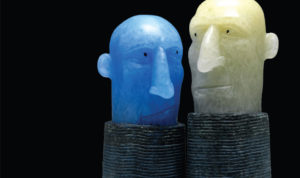Two ceramic heads looking at each other