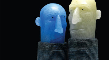Two ceramic heads looking at each other